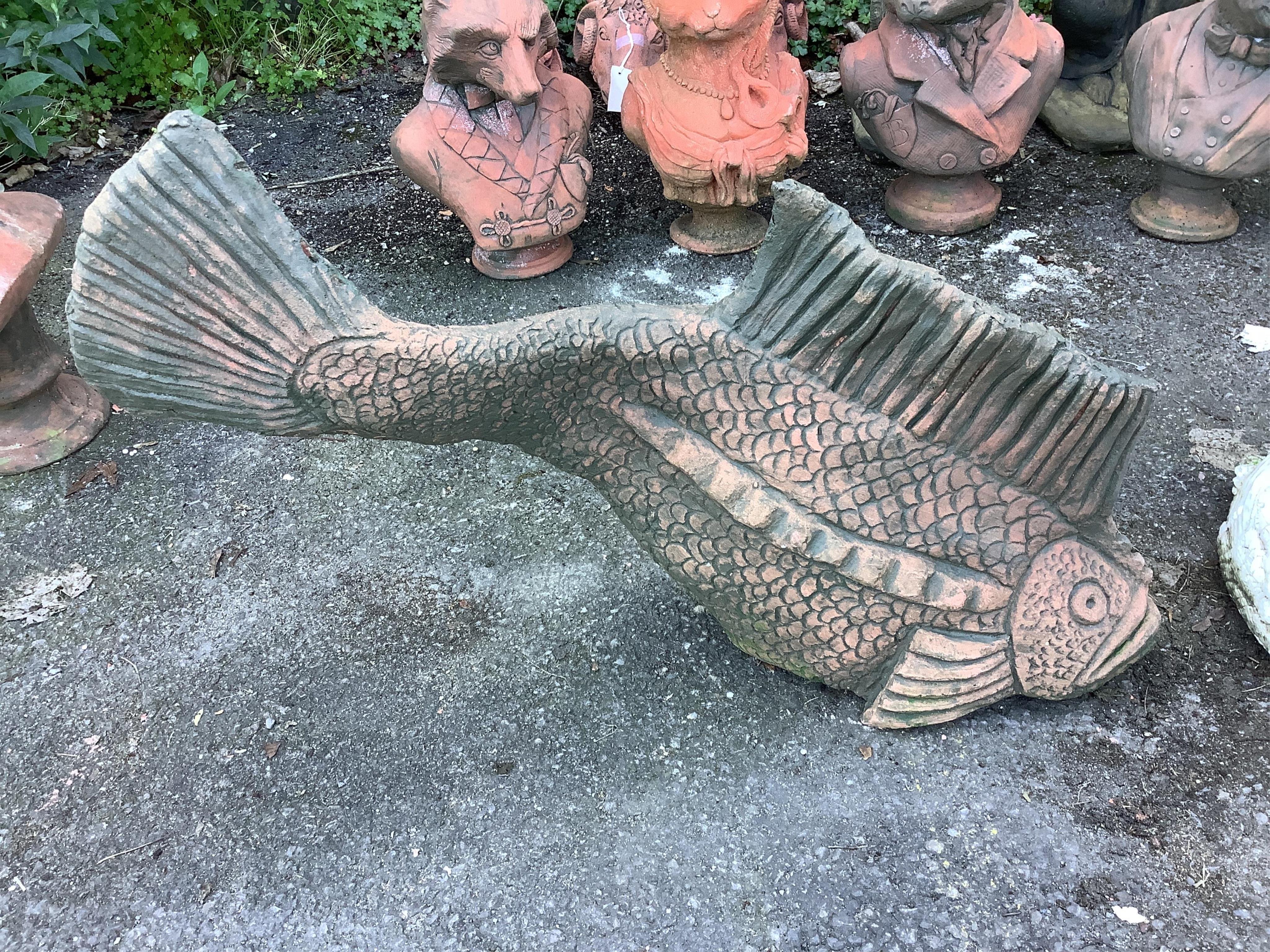 A terracotta koi fish and a pair of terracotta ducks, largest length 70cm. Condition - fair to good
